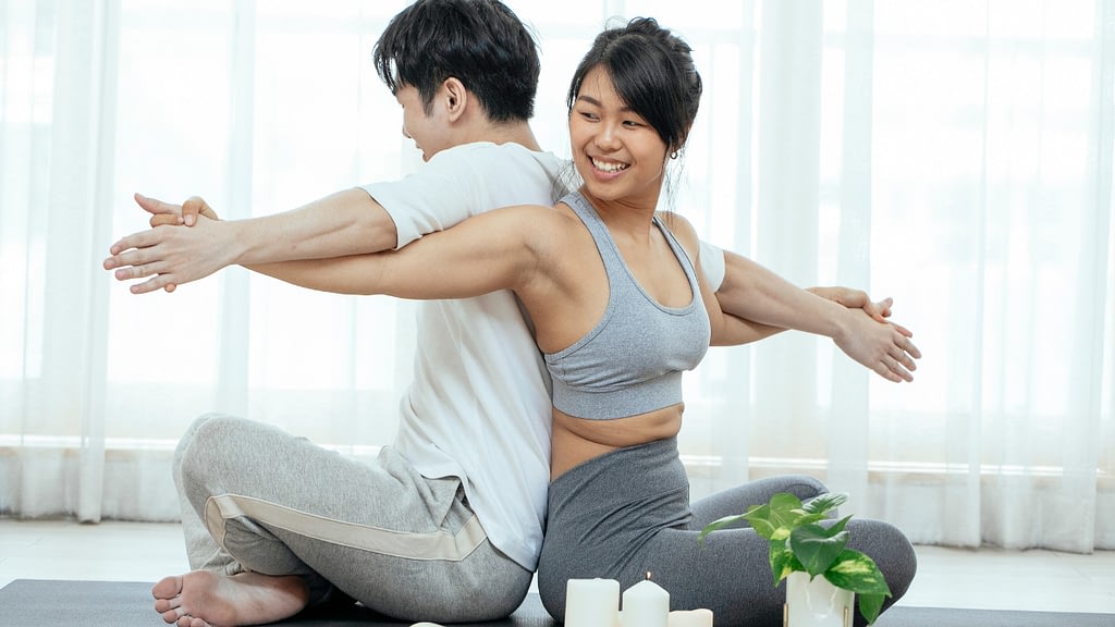 Asian couple doing yoga together.