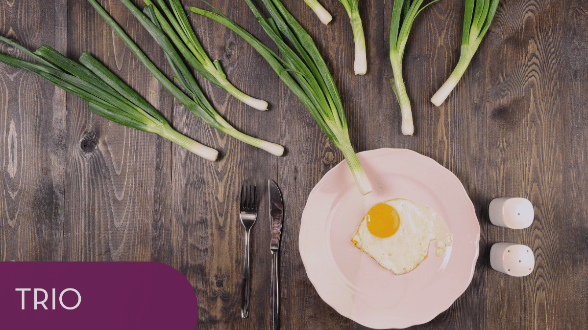 Fake fertilization photo with egg on a plate and fork, knife, vegetables