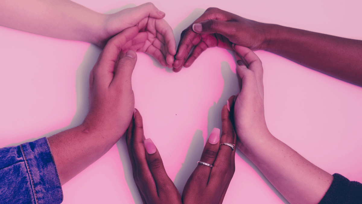 Several different hands forming a heart shape with a pink background