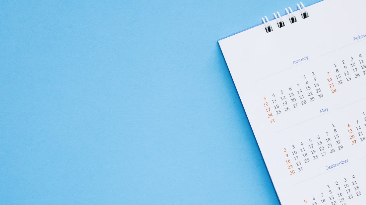 Photo of a calendar with various months and their dates on a blue background