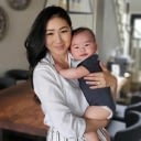 A photograph of a woman holding a baby.