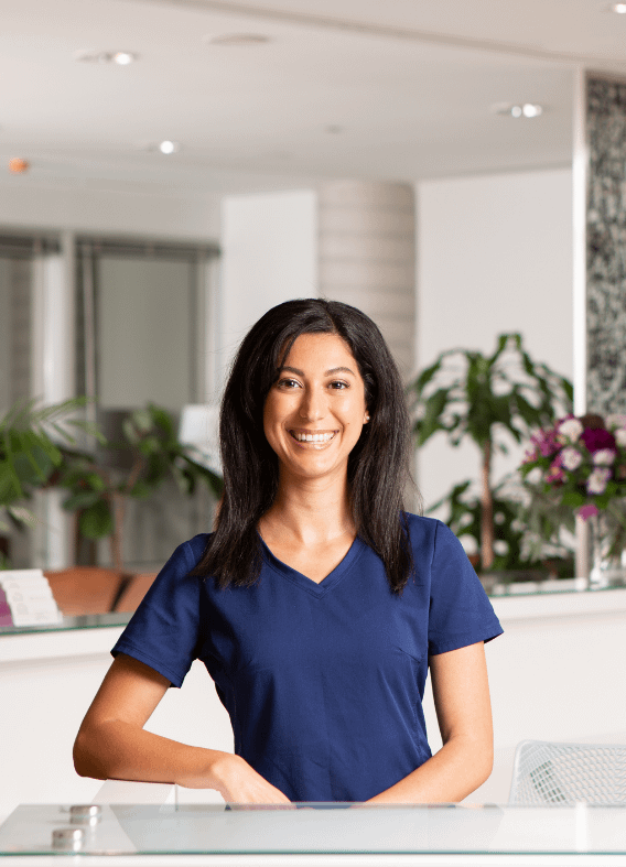 A photograph of a smiling receptionist.
