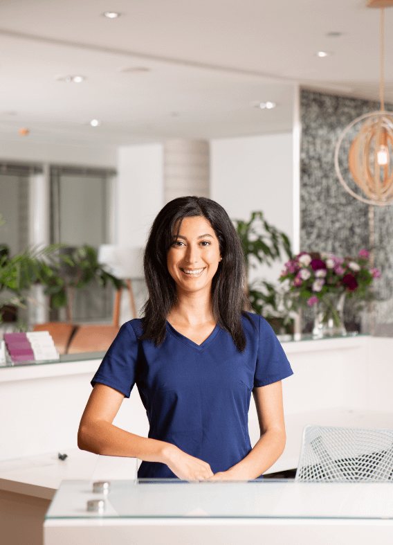 A photograph of a smiling TRIO receptionist.