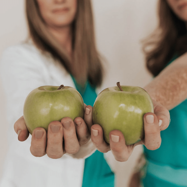 Naturopaths holding apples