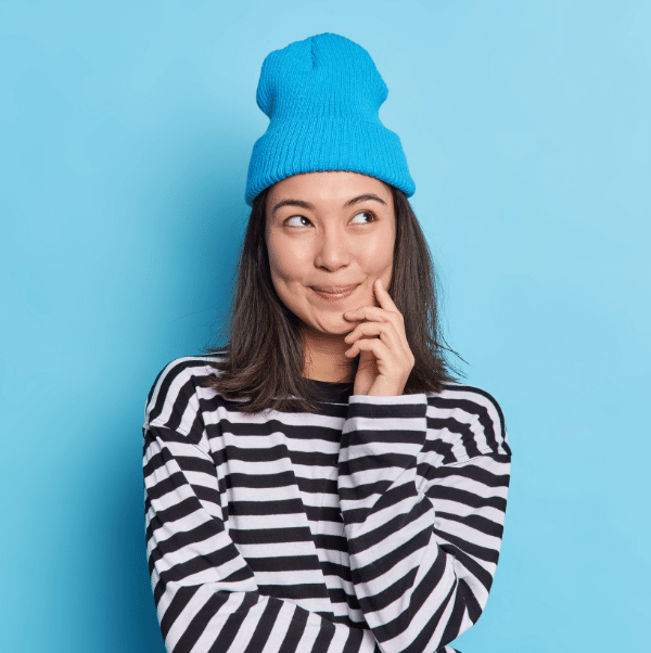 Photo of person in blue hat and black and white sweater