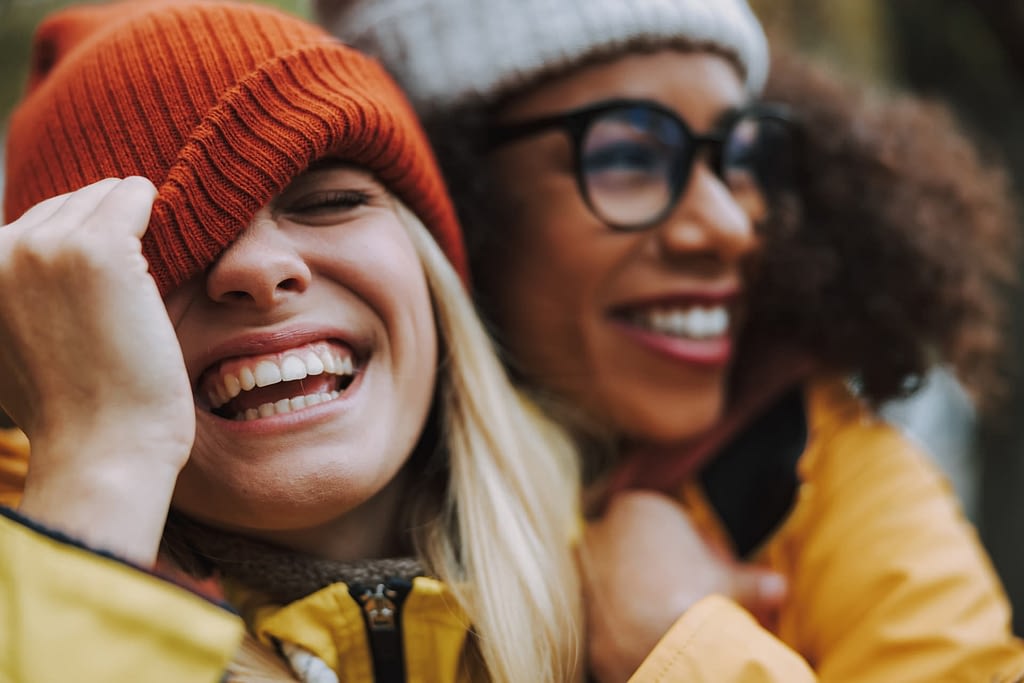 Two smiling people standing close to each other.