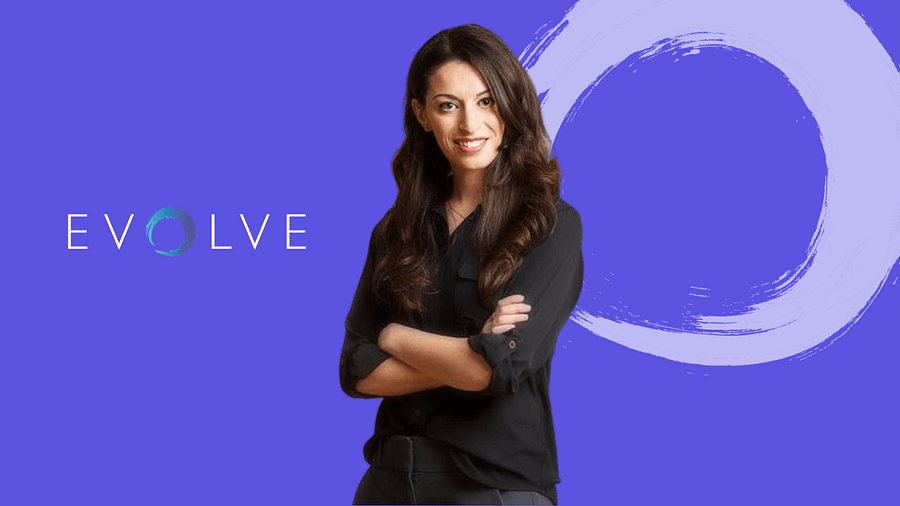 Photo of Dr. Greenberg with black shirt, arms crossed and smiling, purple background and evolve logo