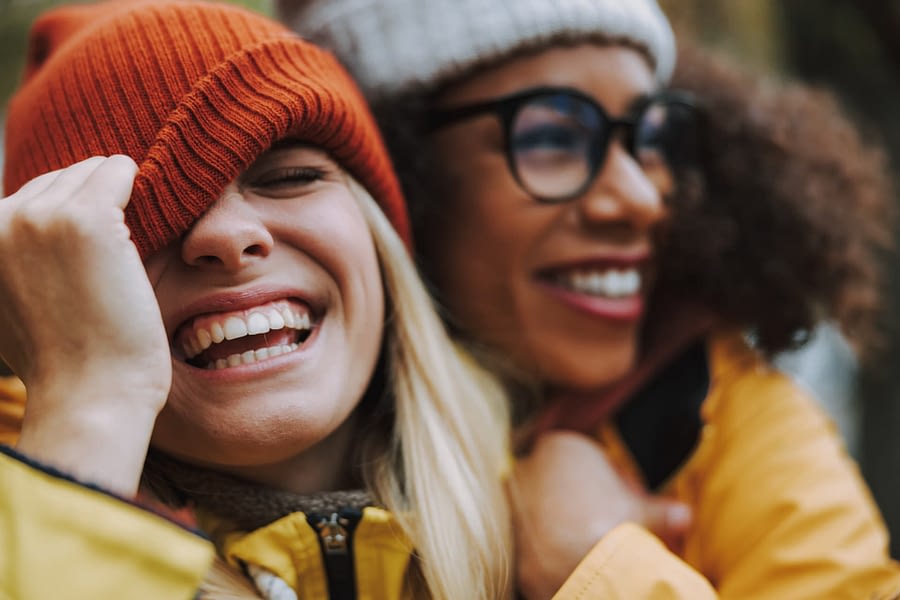Two smiling people standing close to each other.